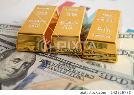 Gold bars with US dollar banknote money, finance trading investment business currency. Gold bars with US dollar banknote money, finance trading investment business currency. 142216788