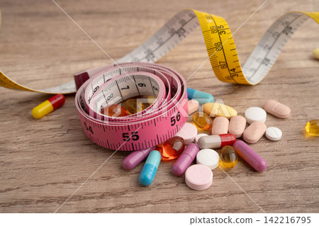 Measuring tape and tablet drug medical for diet. Measuring tape and tablet drug medical for diet. 142216795