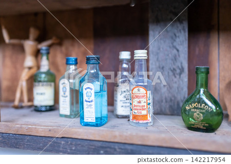 Vintage liquor bottles inside an antique showcase, focus selective Vintage liquor bottles inside an antique showcase, focus selective 142217954