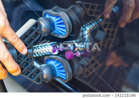 Removing dents on the car. PDR technology. Car body repair without painting. Removing dents on the car. PDR technology. Car body repair without painting. 142218196