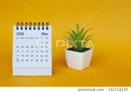 The May 2026 desk calendar with potted plant on yellow background. The May 2026 desk calendar with potted plant on yellow background. 142218220