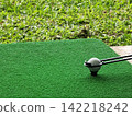 Golf Ball on Tee with Copy Space on Driving Range 142218242