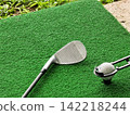Golf Wedge Club and Teed Ball on Green Driving Range Mat 142218244