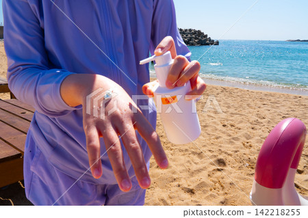 SPF, hands and girl on beach, sand and skincare for summer holiday in Korea SPF, hands and girl on beach, sand and skincare for summer holiday in Korea 142218255