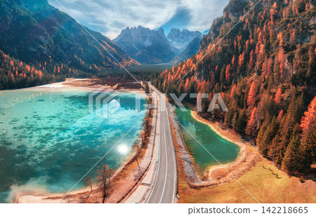 Aerial drone view of road along turquoise alpine lake in autumn Aerial drone view of road along turquoise alpine lake in autumn 142218665