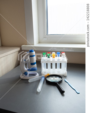 Microbiology-style lab benchtop with child-friendly microscope and test-tube rack, clean and ready Microbiology-style lab benchtop with child-friendly microscope and test-tube rack, clean and ready 142218808