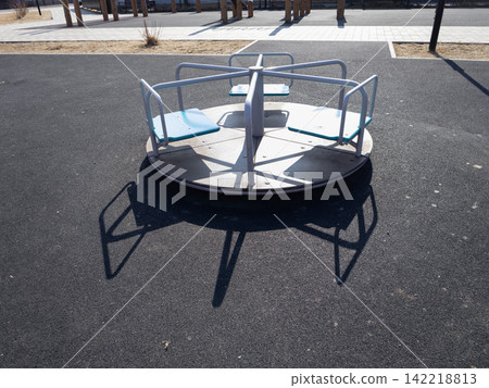 Calm Roundabout Playground Carousel Stationary in an Empty Outdoor Park Calm Roundabout Playground Carousel Stationary in an Empty Outdoor Park 142218813