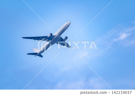 Commercial airplane flying in blue sky Commercial airplane flying in blue sky 142219037
