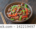 Chinese Beef Stir Fry Garnished With Scallions Sesame Seeds And Chopsticks Beautifully Presented 142219497