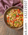Close up Asian udon noodles with shrimp mushrooms sesame glossy savory stir fry 142219507