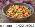 Close up Asian udon noodles with shrimp mushrooms sesame glossy savory stir fry 142219508