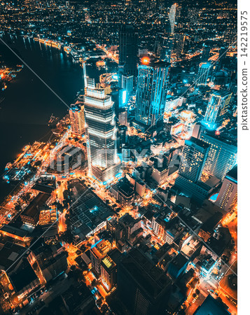 Aerial night view of Ho Chi Minh City skyline with glowing skyscrapers and neon lights, Drone panorama of Saigon downtown, illuminated towers and busy streets of vibrant city Aerial night view of Ho Chi Minh City skyline with glowing skyscrapers and neon lights, Drone panorama of Saigon downtown, illuminated towers and busy streets of vibrant city 142219575