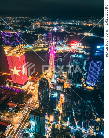 Aerial night view of Ho Chi Minh City skyline with glowing skyscrapers and neon lights, Drone panorama of Saigon downtown, illuminated towers and busy streets of vibrant city Aerial night view of Ho Chi Minh City skyline with glowing skyscrapers and neon lights, Drone panorama of Saigon downtown, illuminated towers and busy streets of vibrant city 142219590