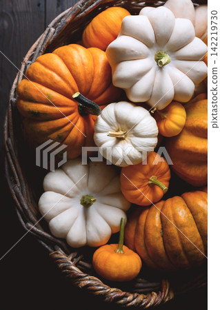 Close-up of wicker basket full of orange pumpkins Close-up of wicker basket full of orange pumpkins 142219730