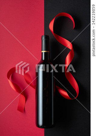 Bottle of red wine with satin ribbons. Bottle of red wine with satin ribbons. 142219859