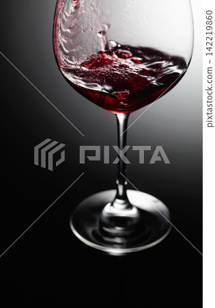 Closeup of red wine pouring. 142219860