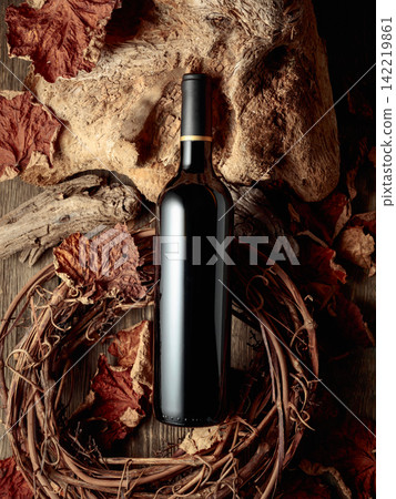 Bottle of red wine on a vintage rustic background. Bottle of red wine on a vintage rustic background. 142219861