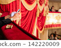 theatre binoculars on red velvet edge of balcony 142220009