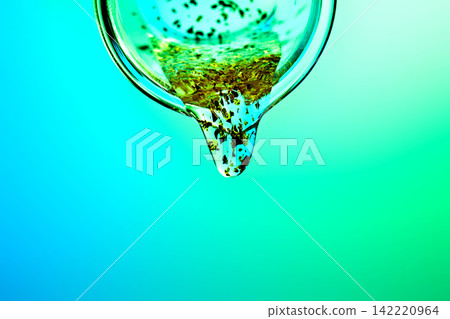 Skincare serum drop featuring gold spicule particles 142220964