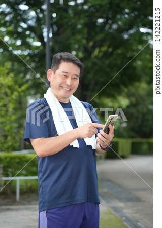 A man operating a smartphone A man operating a smartphone 142221215