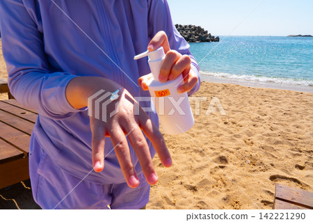 SPF, hands and girl on beach, sand and skincare for summer holiday in Korea SPF, hands and girl on beach, sand and skincare for summer holiday in Korea 142221290
