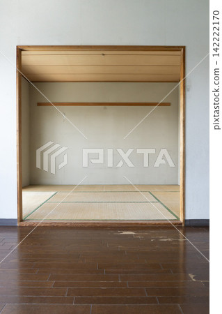 Old tatami room, wooden partition frame, damaged living room floor, before renovation, apartment. Old tatami room, wooden partition frame, damaged living room floor, before renovation, apartment. 142222170