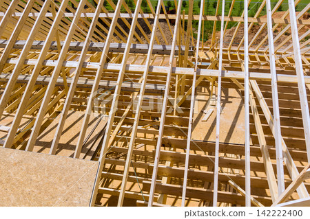 Workers build wooden structure for new building in an open area Workers build wooden structure for new building in an open area 142222400