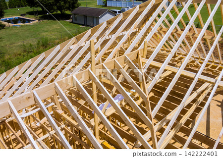 Workers are busy with framework of new building in rural location Workers are busy with framework of new building in rural location 142222401