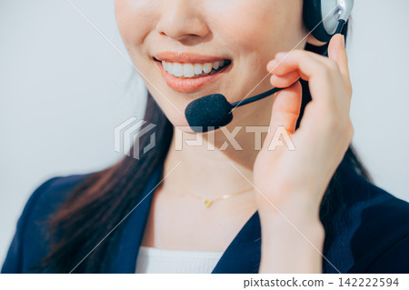 A female operator wearing a headset. 142222594