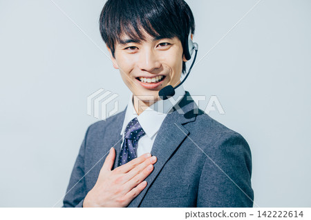 A man in a suit wearing a headset. A man in a suit wearing a headset. 142222614