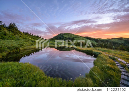 Beautiful reflections in the wetlands and ponds near the summit of Mt. Aizu-Komagatake at sunrise. Beautiful reflections in the wetlands and ponds near the summit of Mt. Aizu-Komagatake at sunrise. 142223302