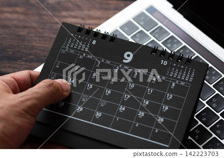 September black calendar and computer September black calendar and computer 142223703