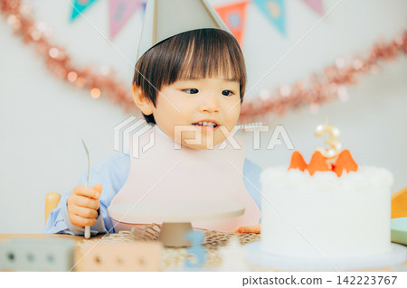 A boy is happy with his birthday cake. A boy is happy with his birthday cake. 142223767