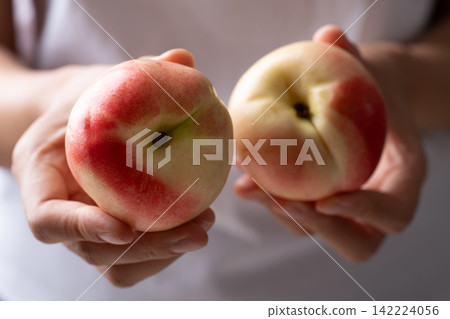 Fresh organic nectarines holding by woman hand 142224056