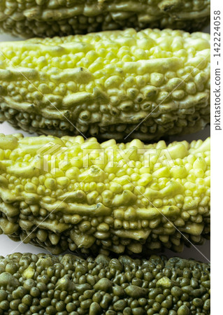 Close-up of fresh green bitter gourd or bitter melon texture background Close-up of fresh green bitter gourd or bitter melon texture background 142224058