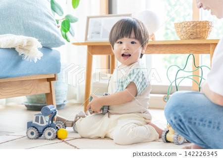 Infants playing with toys Infants playing with toys 142226345