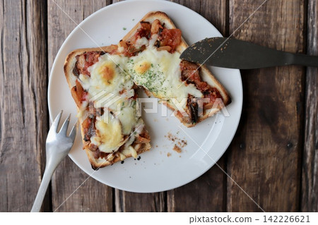 Pizza toast made with leftover eggplant and meat sauce from pasta. Pizza toast made with leftover eggplant and meat sauce from pasta. 142226621