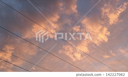 Sunset Sky over Power Transmission Infrastructure and Rural Silhouette Sunset Sky over Power Transmission Infrastructure and Rural Silhouette 142227062