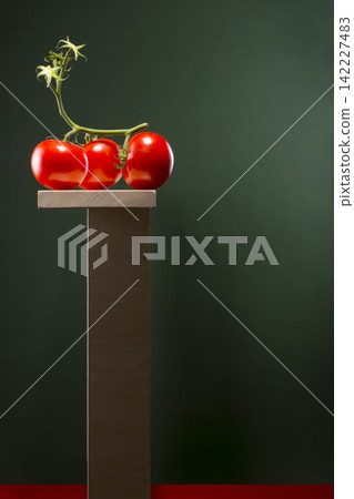 Still life with three tomatoes on a wooden stand Still life with three tomatoes on a wooden stand 142227483