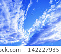 A vibrant blue sky and clouds spreading in a V-shape. 142227935