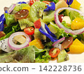 Fresh Mixed Fruit and Vegetable Salad with Kiwi, Orange and Butterfly Pea Flowers 142228736