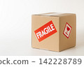 Cardboard box with a "Fragile" sticker on it. 142228789