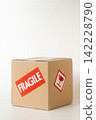 Cardboard box with a "Fragile" sticker on it. 142228790