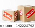 Cardboard box with a "Fragile" sticker on it. 142228792