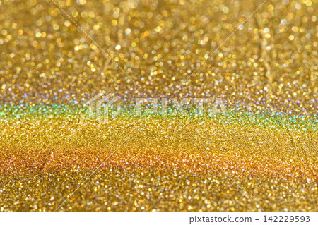 Golden Glitter Surface With Horizontal Rainbow Band Across Center, Showing Dense Metallic Sparkles Golden Glitter Surface With Horizontal Rainbow Band Across Center, Showing Dense Metallic Sparkles 142229593