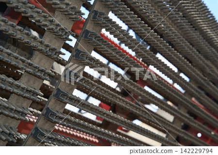 Industrial Chain Conveyor Mechanism Angled Across Frame With Weathered Metal Links And Red Support Industrial Chain Conveyor Mechanism Angled Across Frame With Weathered Metal Links And Red Support 142229794