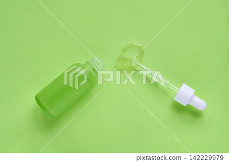 Green Frosted Dropper Bottle With Pipette Removed And Heart Shaped Serum Spill On Monochrome Green Green Frosted Dropper Bottle With Pipette Removed And Heart Shaped Serum Spill On Monochrome Green 142229979