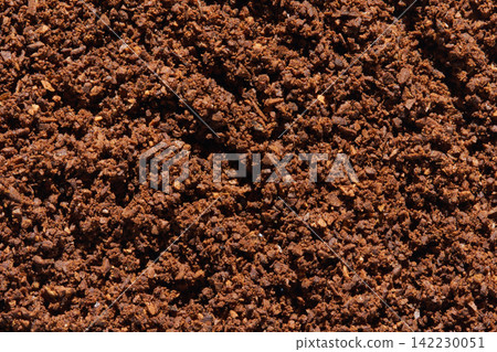 Dense Layer Of Coffee Grounds Filling Frame In Close Up Showing Compact Brown Granules Coarse Dense Layer Of Coffee Grounds Filling Frame In Close Up Showing Compact Brown Granules Coarse 142230051