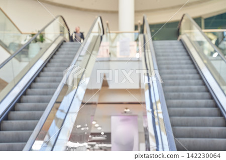 Pair Of Escalators Flanking Empty Central Staircase Inside Bright Mall Atrium With Glass Pair Of Escalators Flanking Empty Central Staircase Inside Bright Mall Atrium With Glass 142230064