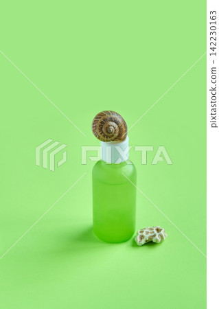 Green Frosted Dropper Bottle Topped By Snail Shell With Small Shell Fragment Beside On Monochrome Green Frosted Dropper Bottle Topped By Snail Shell With Small Shell Fragment Beside On Monochrome 142230163